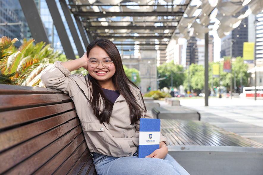 girl student happily sitting in college