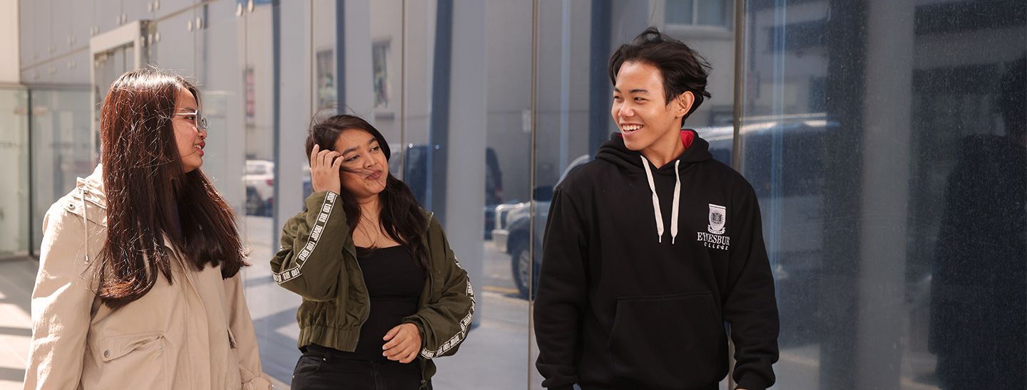 students talking with walking in college