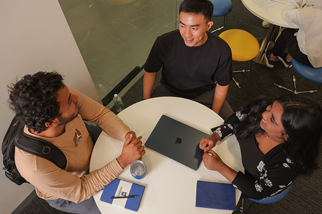 students sitting together on table
