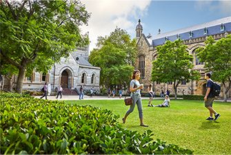 girl and boy student in university garden walking