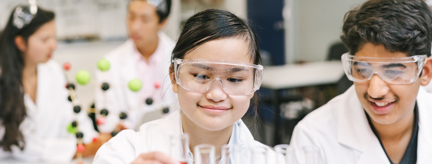 Female and male experimenting in classroom
