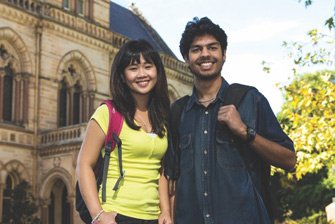 Female and male standing and smiling