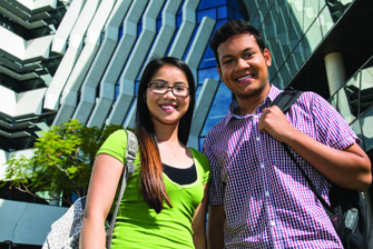 Female and male standing and smiling