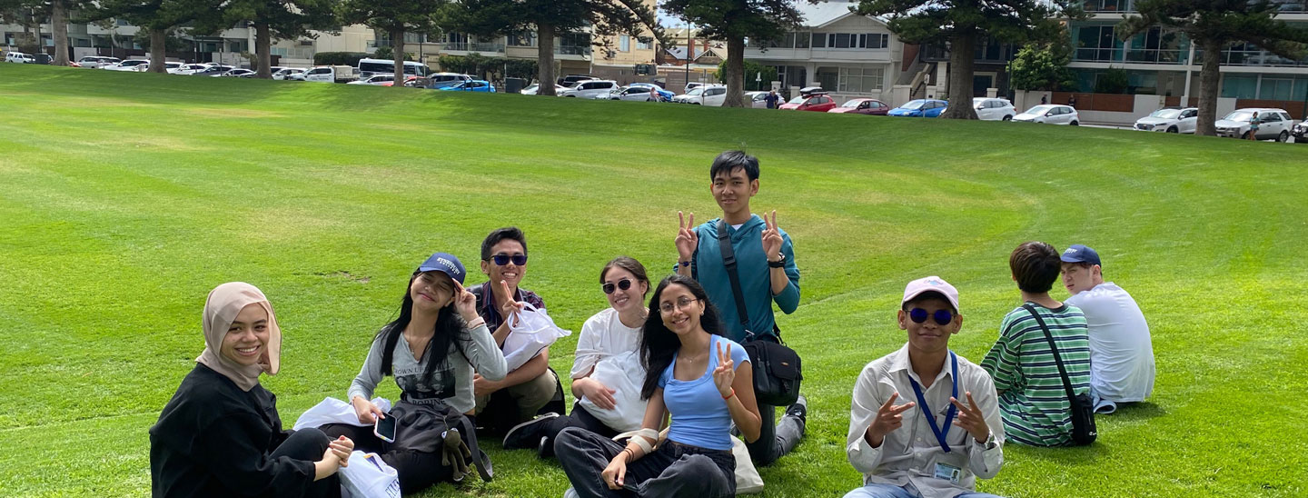 Group of sitting and smiling inground