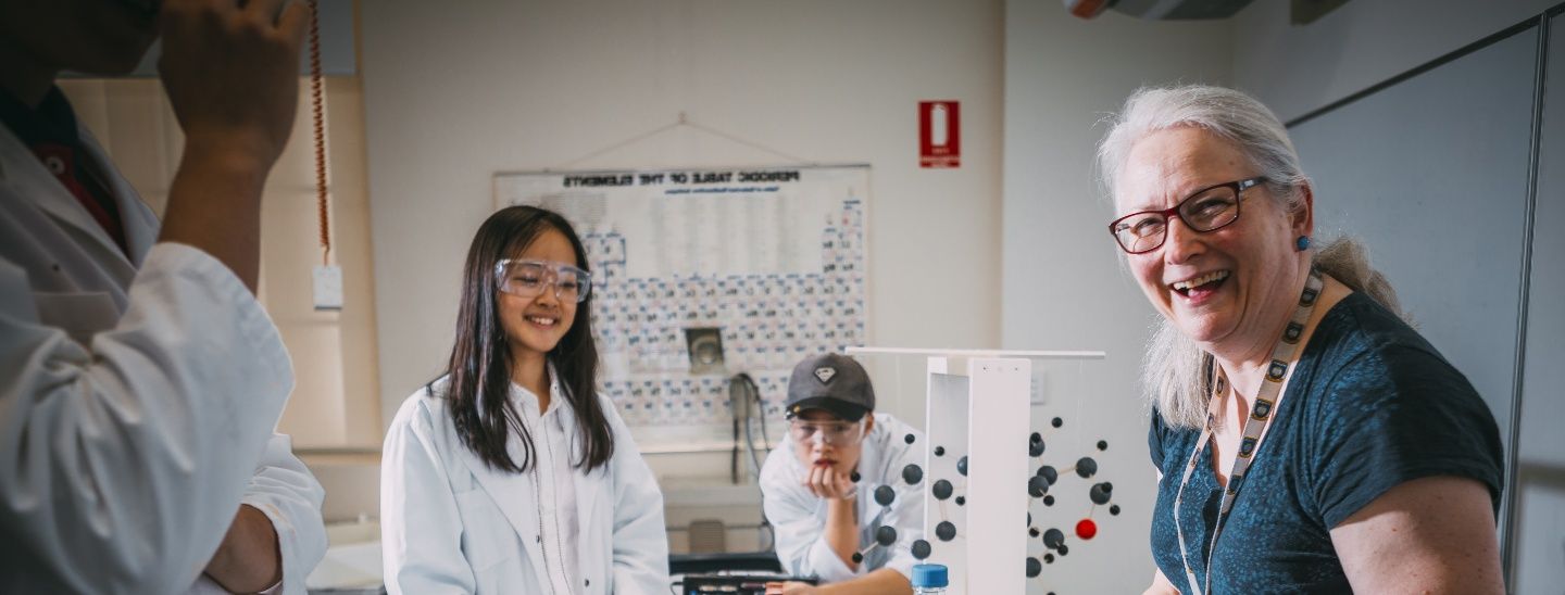 Teacher collaborating with students