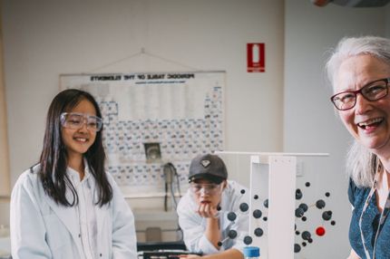 Teacher collaborating with students