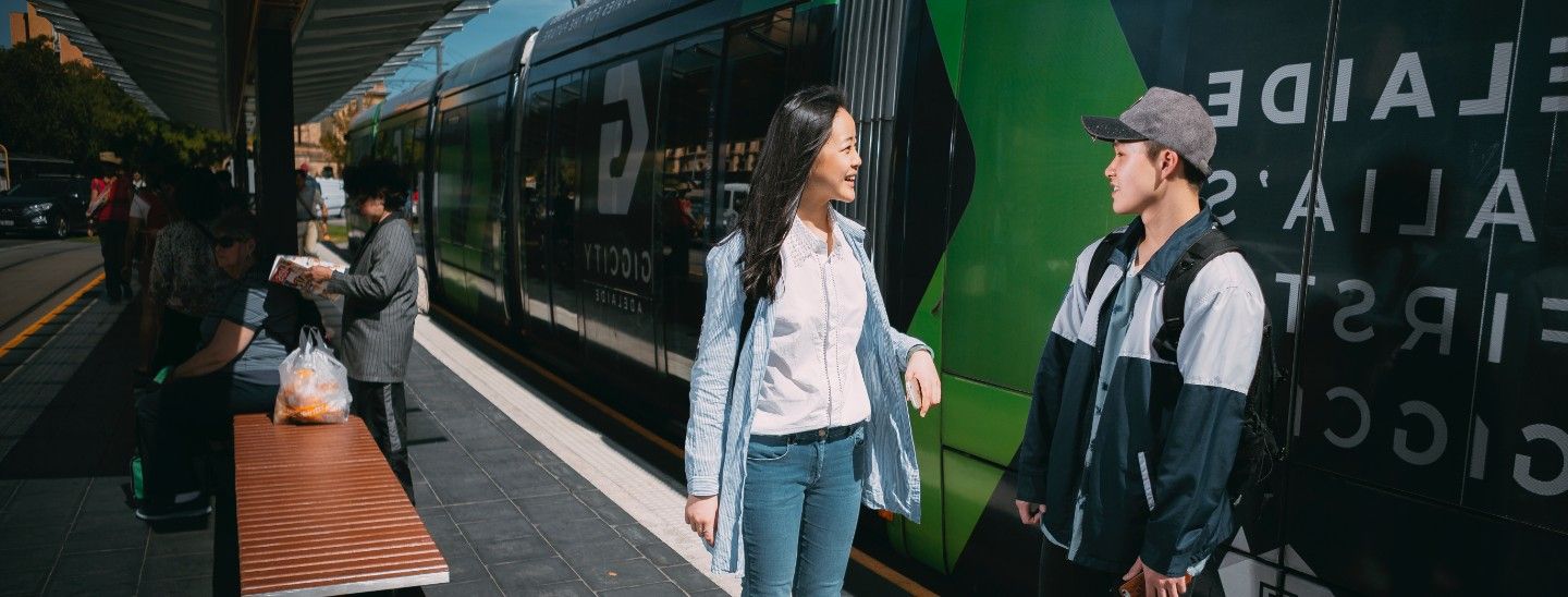 Female and male waiting in train station